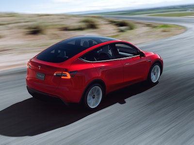 Tesla Model Y driving down the road.