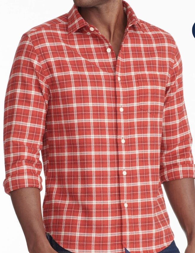 Image of a person wearing a tailored, red plaid flannel button-front shirt.