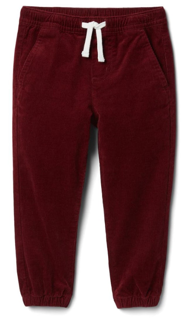 Image of kid-size rust-red corduroy jogger pants.