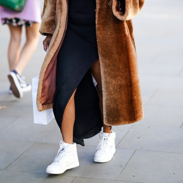 A high-top sneaker outfit with a sweater dress and fur coat. 