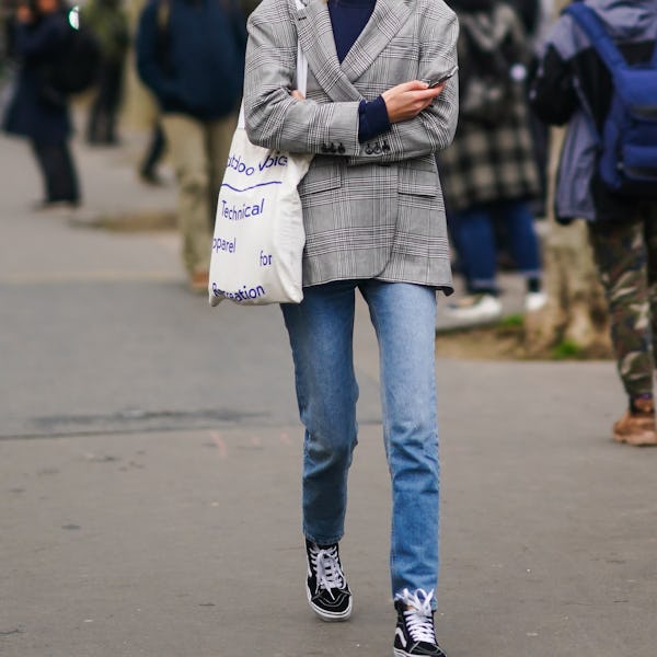 A high-top sneaker outfit with jeans, a sweater, and a blazer.