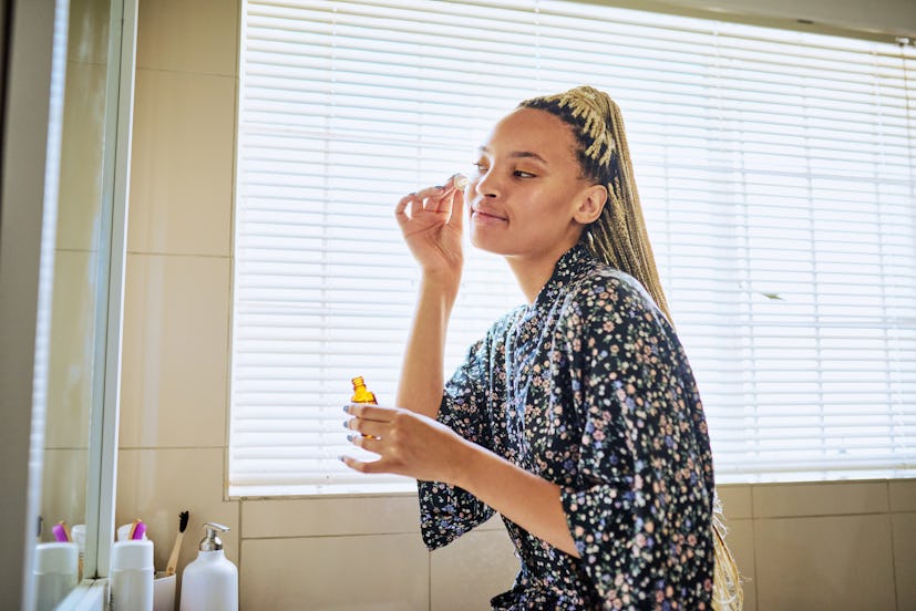 Woman applying face serum
