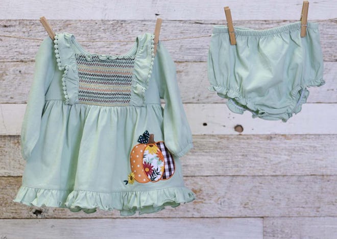 Image of a toddler-size sea-foam green pumpkin dress and bloomers.