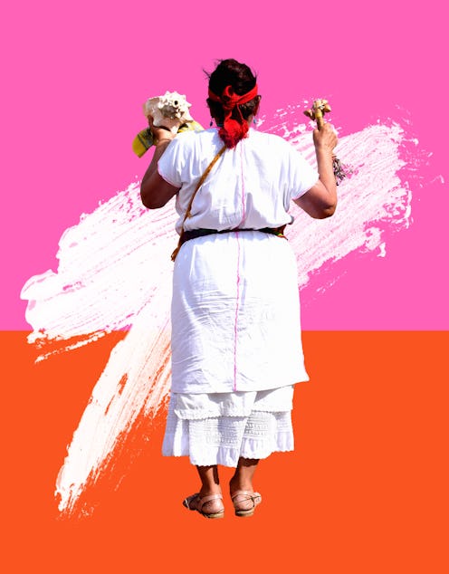 A woman in a white dress holding flowers, practicing curandesimo