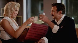 Rebecca and Ted cheersing with tea on 'Ted Lasso', posting a pic on Instagram with an inspiring capt...