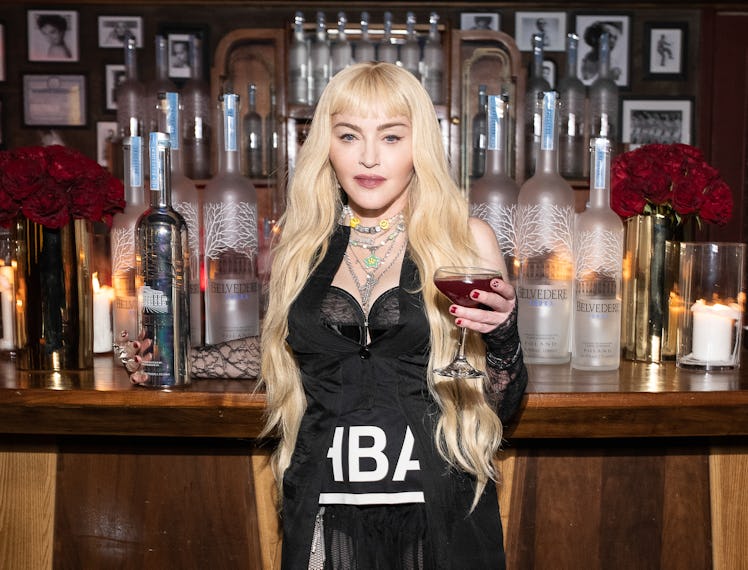 Madonna holding a vodka drink.