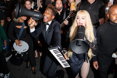 Madonna and John Batiste march in harlem.