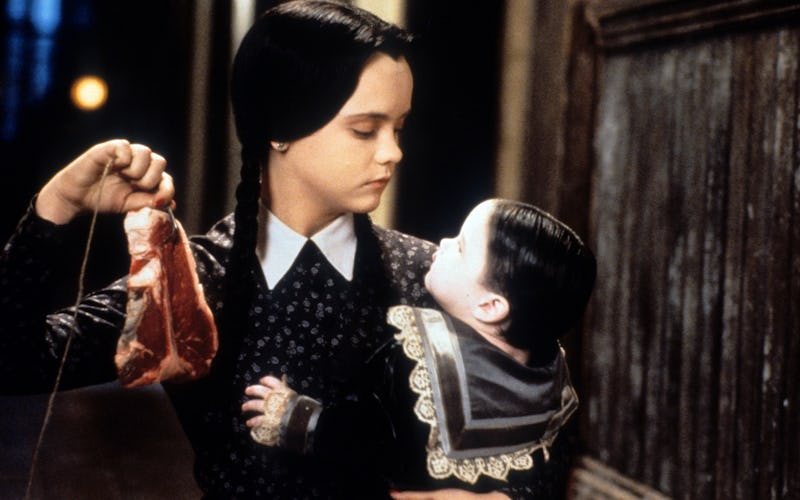 Christina Ricci dangling meat in a scene from the film 'Addams Family Values.'