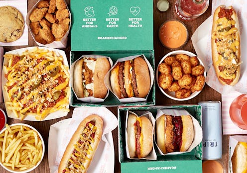 A selection from Neat Burger's menu including nachos, hot dogs, burgers and fries laid out on a tabl...