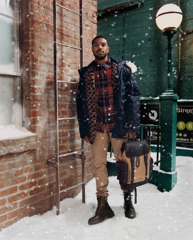 Man standing on the stairs in black boots beige pants plaid blouse blac jacket matched with Coach's ...