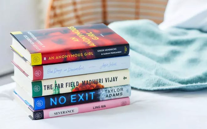 5 books stacked on table- Book Of The Month club