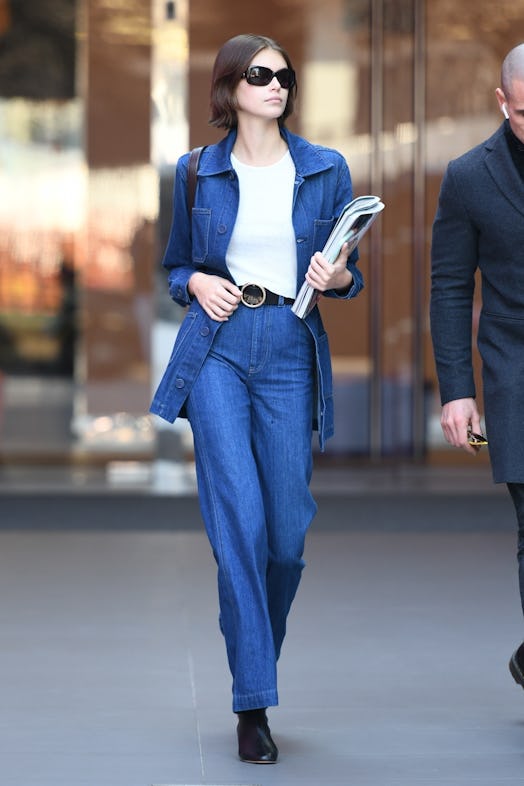 Kaia Gerber wearing Reformation's high-rise wide-leg jeans and denim jacket. 