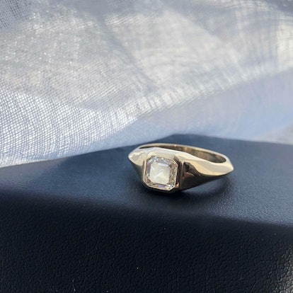 A bezel-set, Asscher diamond ring by Lizzie Mandler.