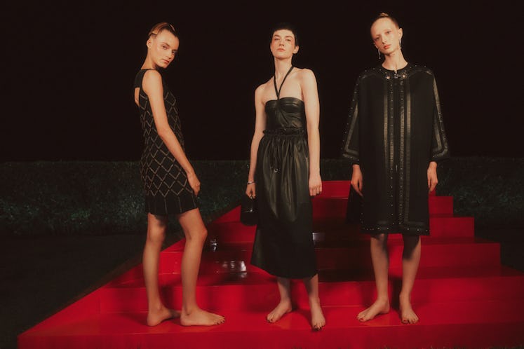 Three models in black dresses at Hermès spring 2022