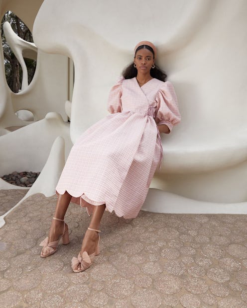 Model wears Loeffler Randal pink dress, headband, sandals.