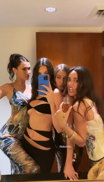 Kendall Jenner in her black cutout dress with Bella Hadid and Hailey Bieber. 