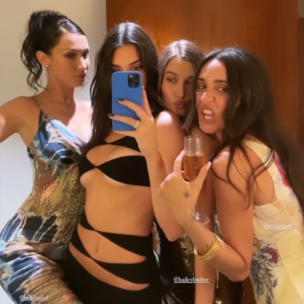 Kendall Jenner in her black cutout dress with Bella Hadid and Hailey Bieber. 