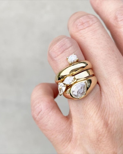 Stacked diamond engagement rings in yellow gold by Grace Lee.