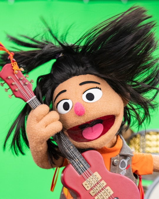 "Sesame Street" muppet Ji-Young rocks out on a pink guitar.