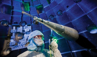 Scientists in a clean room suit inside NIF facility