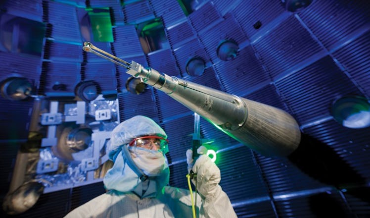 Scientists in a clean room suit inside NIF facility