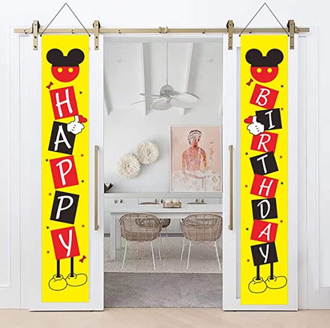 Image of a pair of hanging vertical Happy Birthday banners with Mickey Mouse print.
