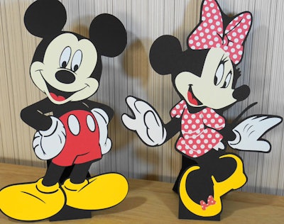 Image of two standing table-top cut-outs of Mickey Mouse and Minnie Mouse