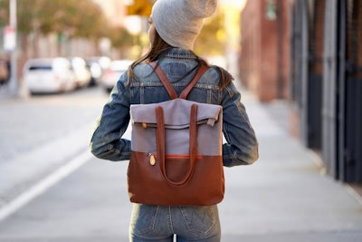 Shot of woman's back, wearing two-tone backpack