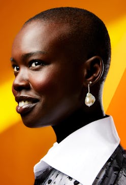 Model wears a pearl drop earring with a diamond-encrusted hoop.