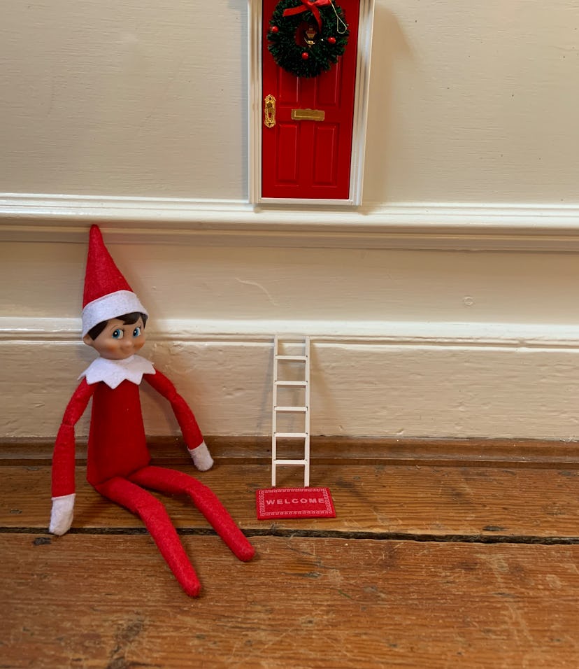 Elf on the Shelf arrival idea: place them under a little faux door with wreathh