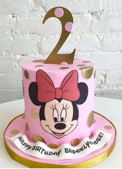 Image of a Minnie Mouse themed round vertical birthday cake.