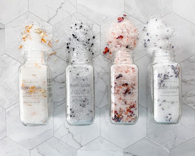 Product image; four containers of colorful bath salts