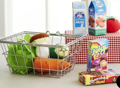 Image of a kid's toy grocery set, with metal shopping basket, fabric foods and boxed grocery items.