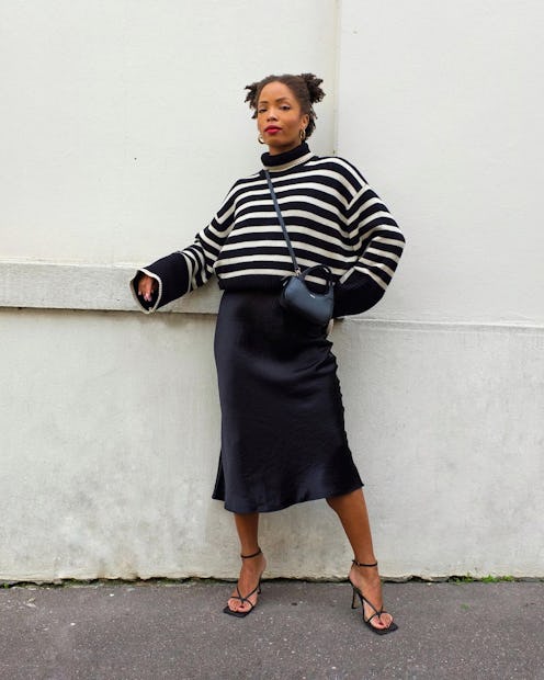Ellie Delphine wearing navy and white striped sweater over a blue slip dress.
