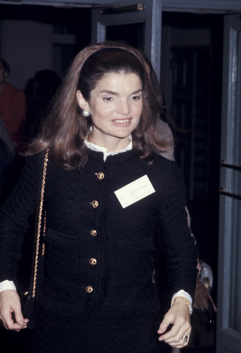 Jackie Onassis sporting longer hair pulled back by a thin headband at Caroline Kennedy’s school dinn…