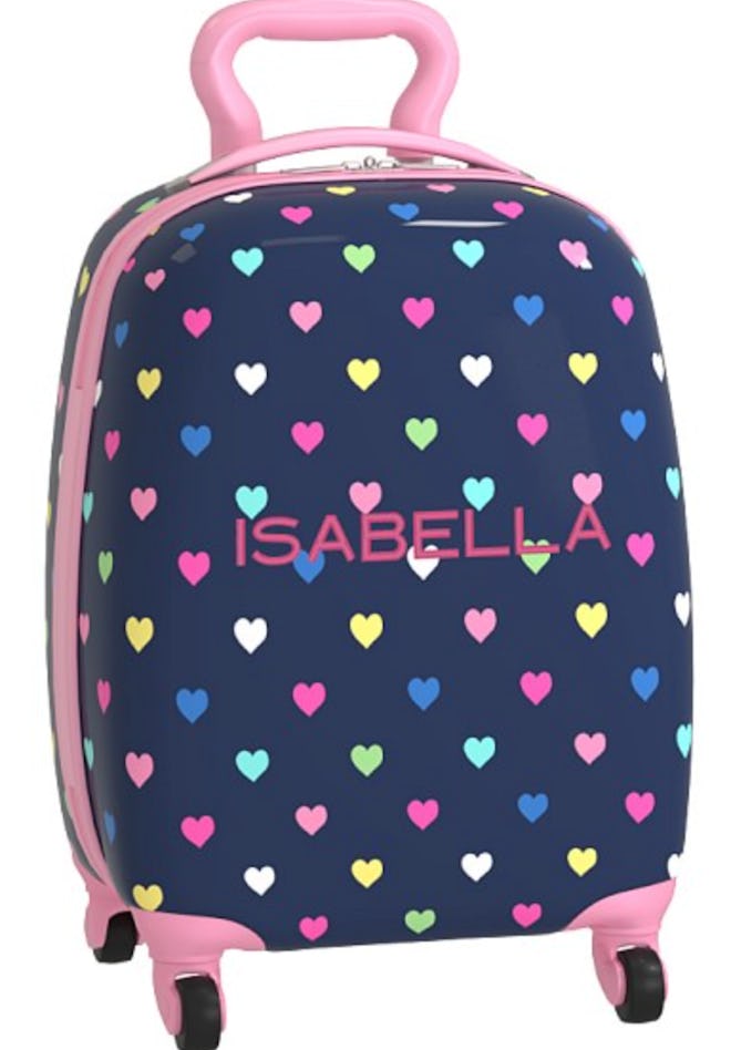 Image of small, navy wheeled suitcase with personalized name and multicolor heart print.