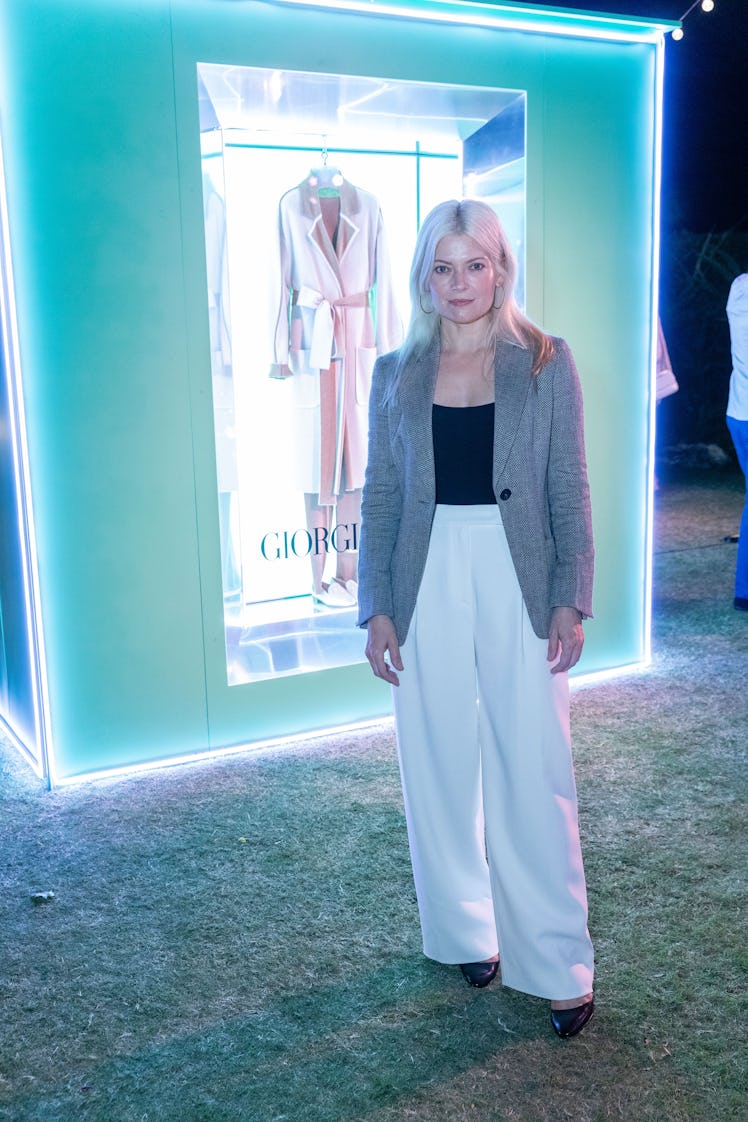 Stylist Kate Young standing in front of a Giorgio Armani vitrine