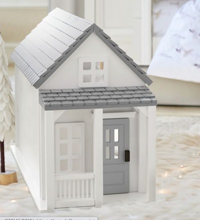 Image of a toy cottage-style dollhouse. 