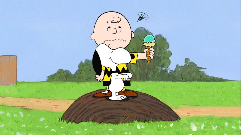 Charlie Brown rolls his eyes as Snoopy attempts to take his ice cream