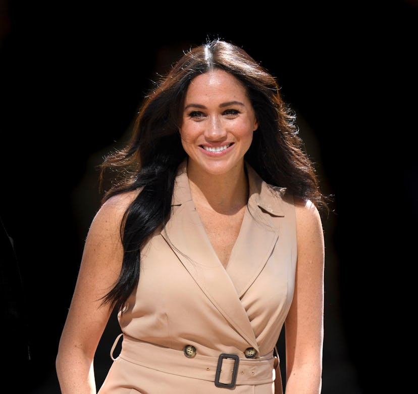 Meghan Markle in a tan trench coat dress at the University of Johannesburg.