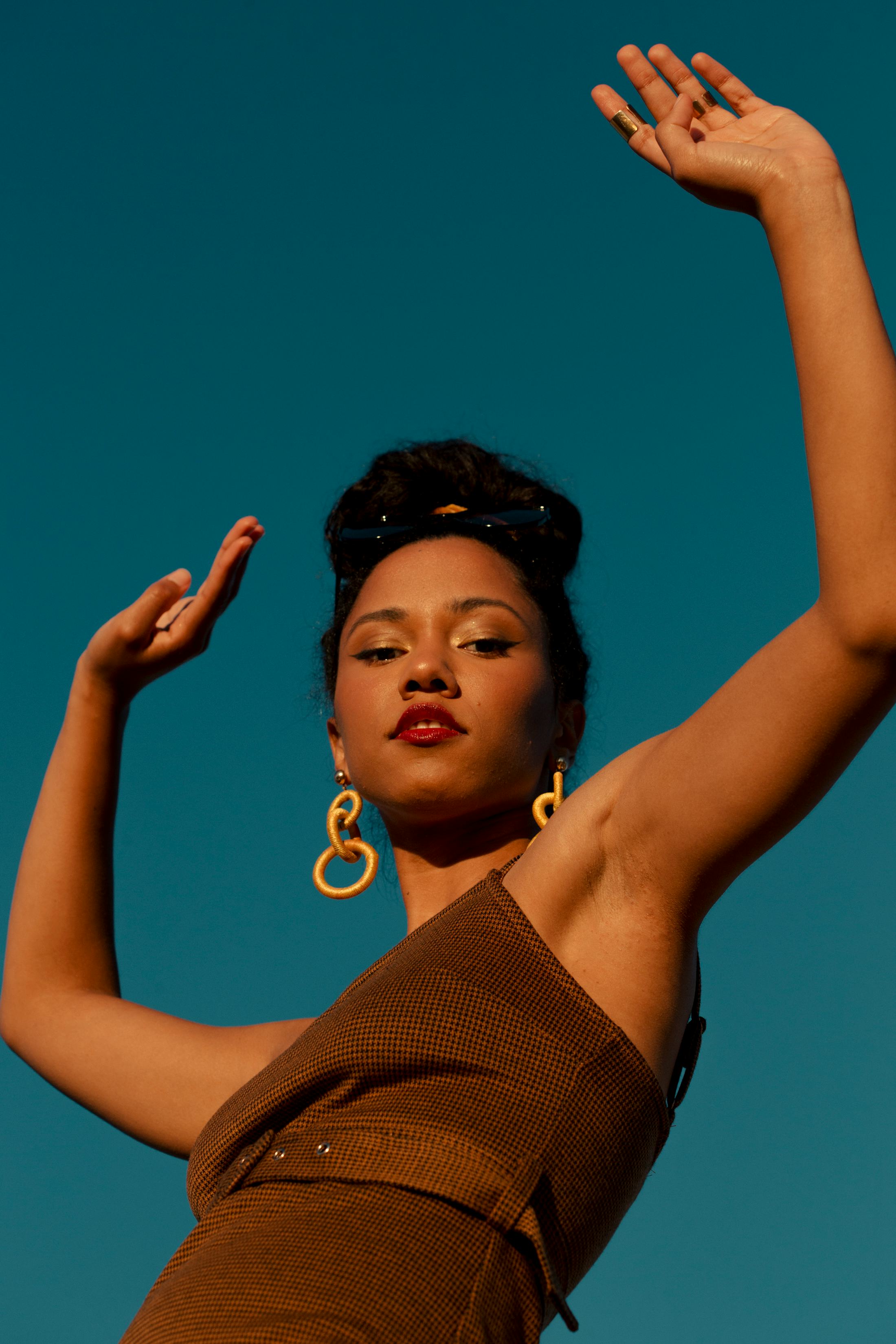 Young woman with her arms in the air, celebrating the December 2021 new moon solar eclipse on Dec. 4...