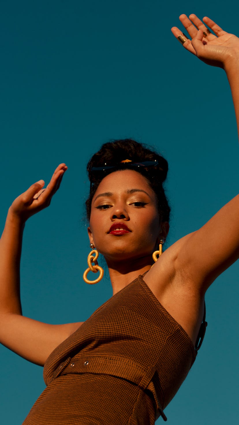 Young woman with her arms in the air, celebrating the December 2021 new moon solar eclipse on Dec. 4...
