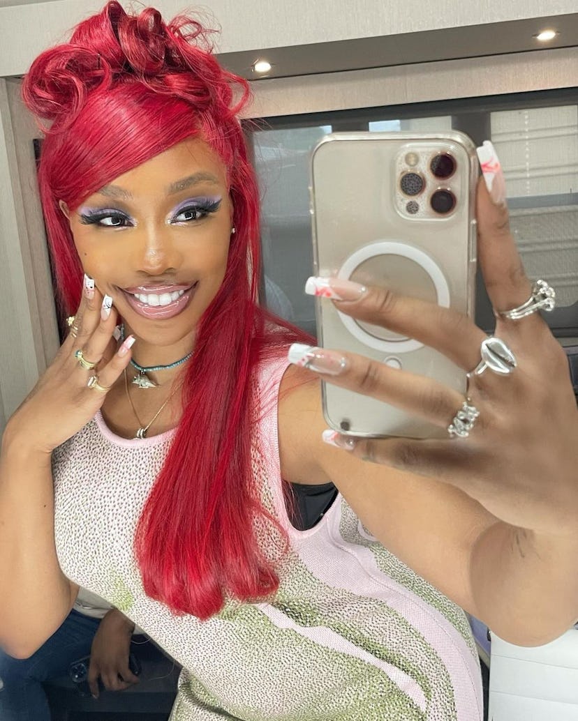 SZA's red hot half up, half down hairstyle is super on trend.