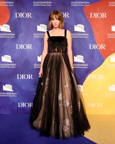 Maya Hawke posing in a black Dior dress