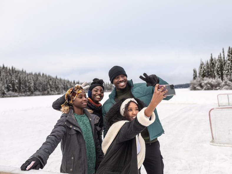 Group of friends taking a selfie in the snow on December 29, 2021, the best day of the month for eve...