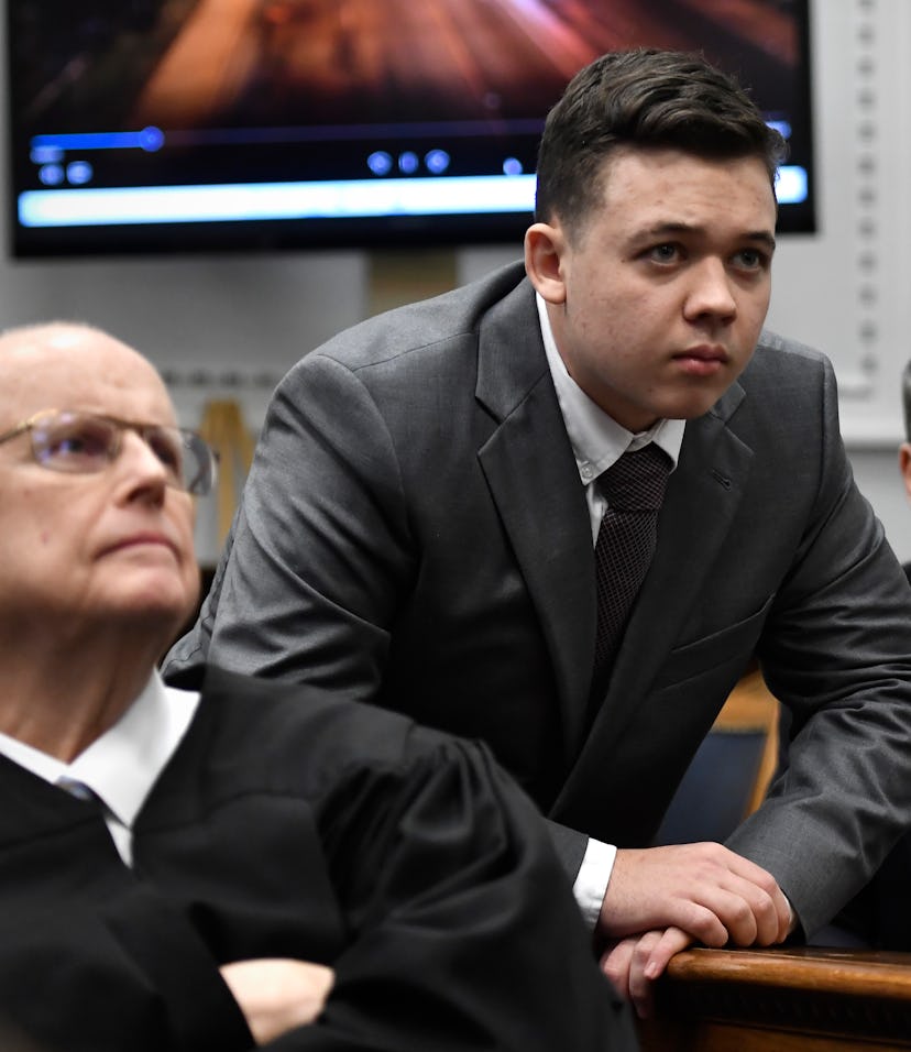 Judge Bruce Schroeder, left, Kyle Rittenhouse, center, along with his attorney Mark Richards watch a...