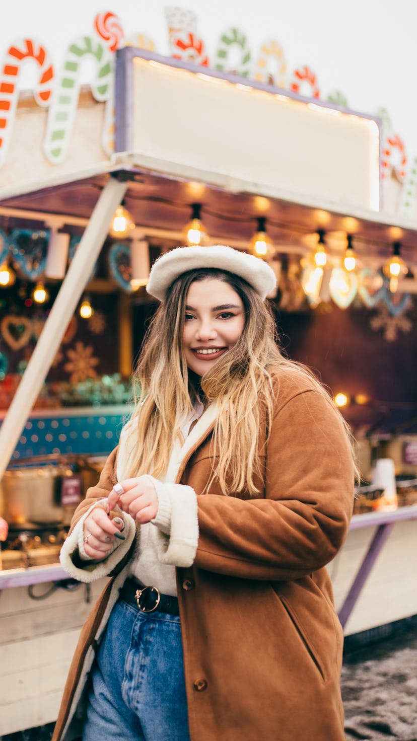 Young woman at Christmas market on December 29, 2021, the best day of the month for every zodiac sig...