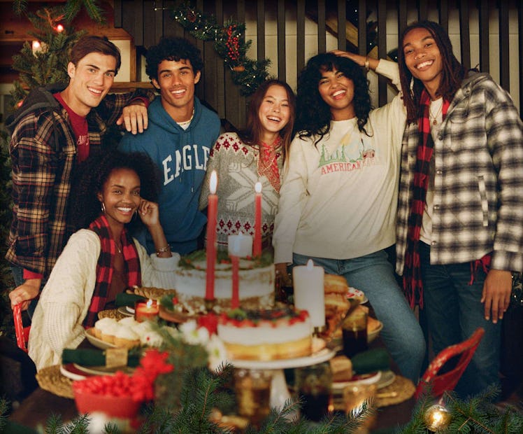 A group of friends at a dinner wearing all American Eagle clothing.