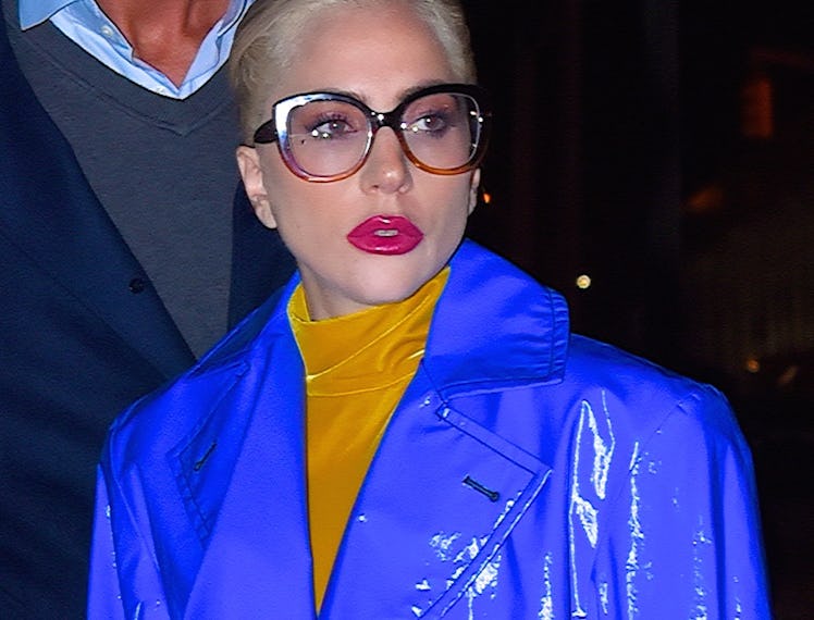 Lady Gaga in glasses and blue coat.