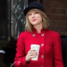 Taylor Swift in a hat holding a Starbucks cup to show Taylor Swift lyrics for fall-inspired Instagra...